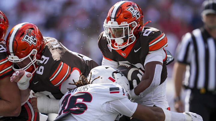 Sep 6, 2025; Cincinnati, Ohio, USA; Bowling Green Falcons running back Cameron Pettaway (26) carries the ball as he is tackled by Cincinnati Bearcats safety Xavier Williams (36) in the first half at Nippert Stadium. Sep 6, 2025; Cincinnati, Ohio, USA; Bowling Green Falcons running back Cameron Pettaway (26) carries the ball as he is tackled by Cincinnati Bearcats safety Xavier Williams (36) in the first half at Nippert Stadium.