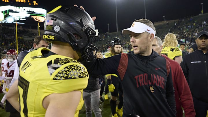 Nov 11, 2023; Eugene, Oregon, USA; USC Trojans head coach Lincoln Riley congratulates Oregon Ducks quarterback Bo Nix (10) after a game at Autzen Stadium. Mandatory Credit: Troy Wayrynen-Imagn Images Nov 11, 2023; Eugene, Oregon, USA; USC Trojans head coach Lincoln Riley congratulates Oregon Ducks quarterback Bo Nix (10) after a game at Autzen Stadium. Mandatory Credit: Troy Wayrynen-Imagn Images