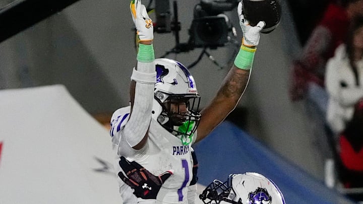Dec 6, 2024; Birmingham, AL, USA; Parker's Kameron Scarver (56) lifts Parker's Na'eem Offord (1) in celebration after Offord scored against Saraland at Protective Stadium in the 6A State Championship game.