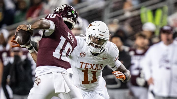 Nov 30, 2024; College Station, Texas, USA; Texas A&M Aggies quarterback Marcel Reed (10) looks to evade defense from Texas Longhorns linebacker Colin Simmons (11) in the second quarter of the Lone Star Showdown at Kyle Field. Mandatory Credit: Sara Diggins/USA TODAY Network via Imagn Images