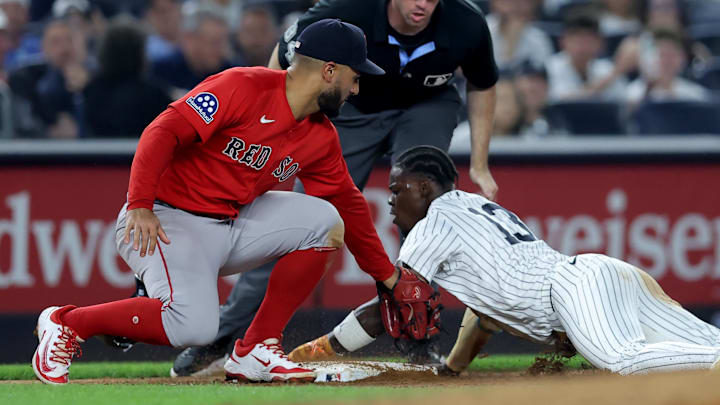 Jun 6, 2025; Bronx, New York, USA; New York Yankees third baseman Jazz Chisholm Jr. (13) is tagged out trying to steal third base by Boston Red Sox third baseman Abraham Toro (29) during the sixth inning at Yankee Stadium. Mandatory Credit: Brad Penner-Imagn Images