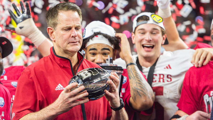 Indiana Head Coach Curt Cignetti looks at the trophy after the Indiana versus Ohio State Big Ten Championship football game at Lucas Oil Stadium on Saturday, Dec. 6, 2025.