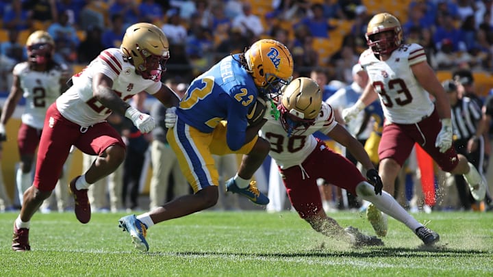 Oct 4, 2025; Pittsburgh, Pennsylvania, USA;  Pittsburgh Panthers wide receiver Zion Fowler-El (23) crosses the goal line to score a touchdown against Boston College Eagles defensive backs Marcus Upton (20) and TJ Green (30) during the third quarter at Acrisure Stadium. Mandatory Credit: Charles LeClaire-Imagn Images