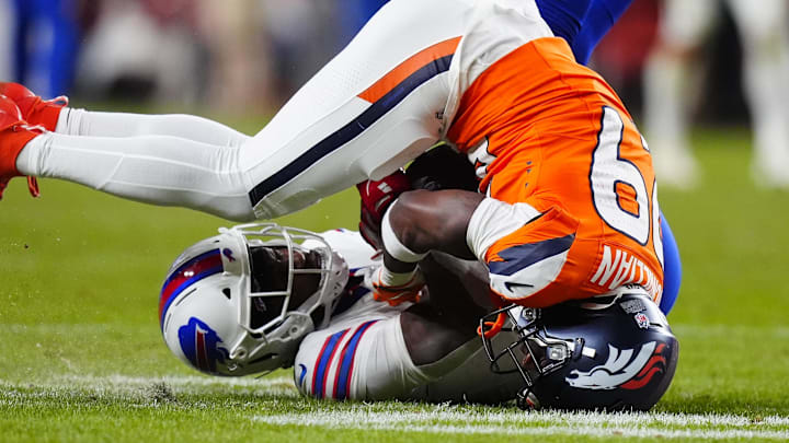 Denver Broncos cornerback Ja'quan McMillian (29) intercepts a pass intended for Buffalo Bills wide receiver Brandin Cooks (18) during overtime of an AFC Divisional Round playoff game at Empower Field at Mile High.