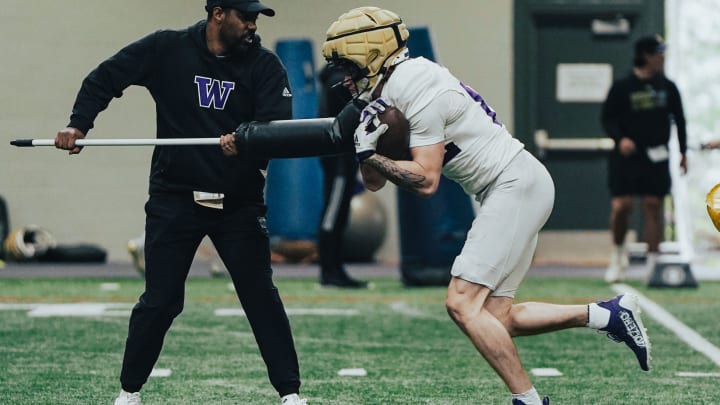 Tight end Owen Coutts runs through a tight-end drill in Dempsey Indoor.