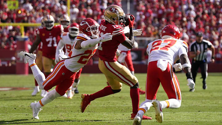 Oct 20, 2024; Santa Clara, California, USA; San Francisco 49ers wide receiver Brandon Aiyuk (11) catches a pass between Kansas City Chiefs cornerback Trent McDuffie (22) and safety Chamarri Conner (27) in the second quarter at Levi's Stadium. Mandatory Credit: Cary Edmondson-Imagn Images
