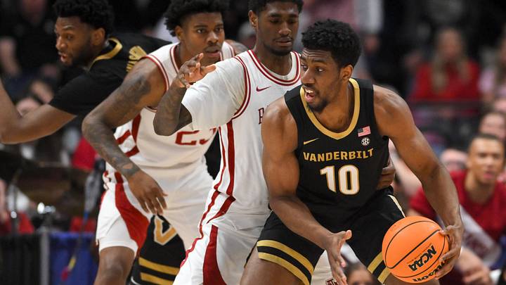 Mar 15, 2026; Nashville, TN, USA; Vanderbilt Commodores forward Ak Okereke (10) has the ball defended by Arkansas Razorbacks guard D.J. Wagner (21) in the first half during the men's SEC Conference Tournament Championship at Bridgestone Arena. Mandatory Credit: Steve Roberts-Imagn Images