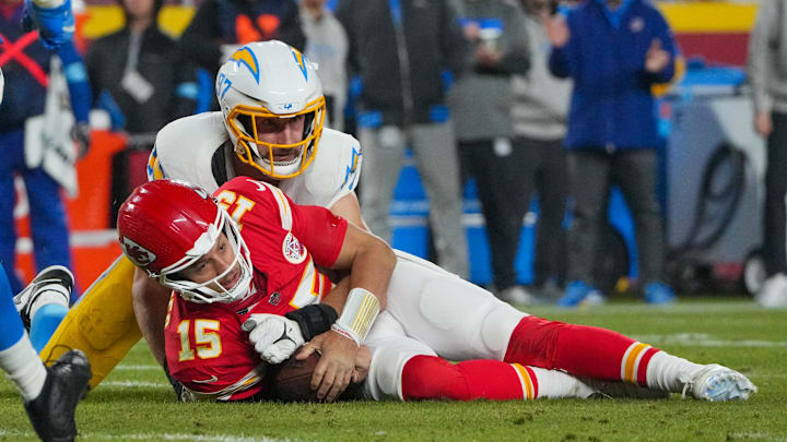 Dec 8, 2024; Kansas City, Missouri, USA; Kansas City Chiefs quarterback Patrick Mahomes (15) is sacked by Los Angeles Chargers linebacker Joey Bosa (97) during the first half at GEHA Field at Arrowhead Stadium. Mandatory Credit: Denny Medley-Imagn Images