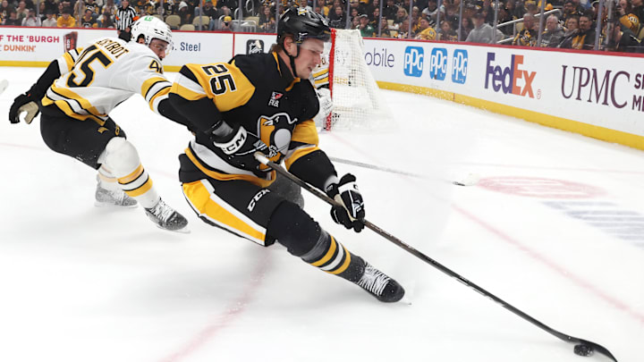 Mar 8, 2026; Pittsburgh, Pennsylvania, USA;  Pittsburgh Penguins right wing Elmer Soderblom (25) moves the puck against Boston Bruins defenseman Jonathan Aspirot (45) during the first period at PPG Paints Arena. Mandatory Credit: Charles LeClaire-Imagn Images