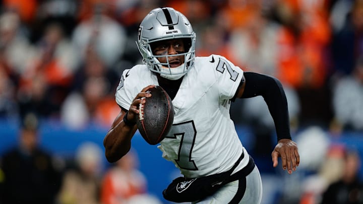Nov 6, 2025; Denver, Colorado, USA; Las Vegas Raiders quarterback Geno Smith (7) scrambles with the ball in the fourth quarter against the Denver Broncos at Empower Field at Mile High. Mandatory Credit: Isaiah J. Downing-Imagn Images