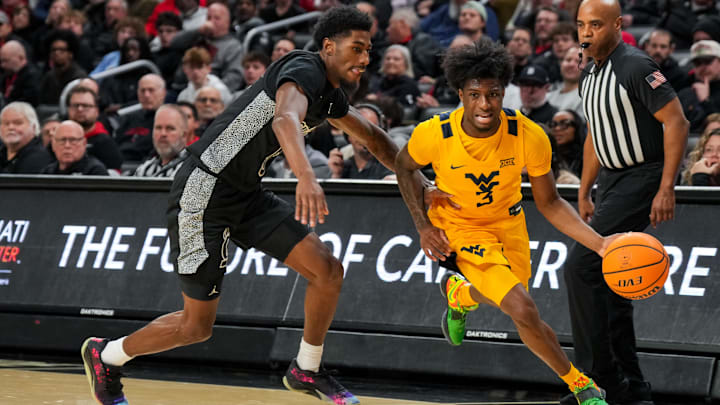Feb 5, 2026; Cincinnati, Ohio, USA; West Virginia Mountaineers guard Honor Huff (3) dribbles the ball against Cincinnati Bearcats guard Sencire Harris (5) in the second half at Fifth Third Arena. Mandatory Credit: Aaron Doster-Imagn Images Feb 5, 2026; Cincinnati, Ohio, USA; West Virginia Mountaineers guard Honor Huff (3) dribbles the ball against Cincinnati Bearcats guard Sencire Harris (5) in the second half at Fifth Third Arena. Mandatory Credit: Aaron Doster-Imagn Images