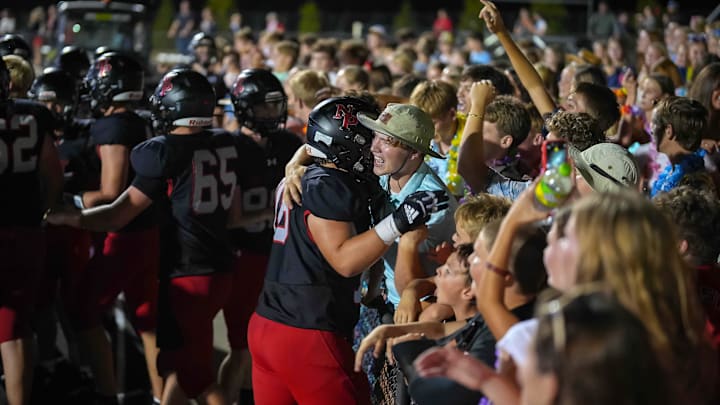 Members of the North Polk football team celebrate with fans after beating ADM-Adel in overtime Friday, Sept. 12, 2025, during a high school football game at North Polk Stadium in Alleman. Mandatory Credit: Bryon Houlgrave-The Des Moines Register