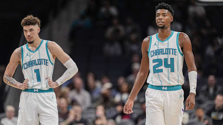 Oct 8, 2024; Charlotte, North Carolina, USA; Charlotte Hornets guard LaMelo Ball (1) and forward Brandon Miller (24) at mid court against the Miami Heat during the second half at Spectrum Center. Mandatory Credit: Jim Dedmon-Imagn Images