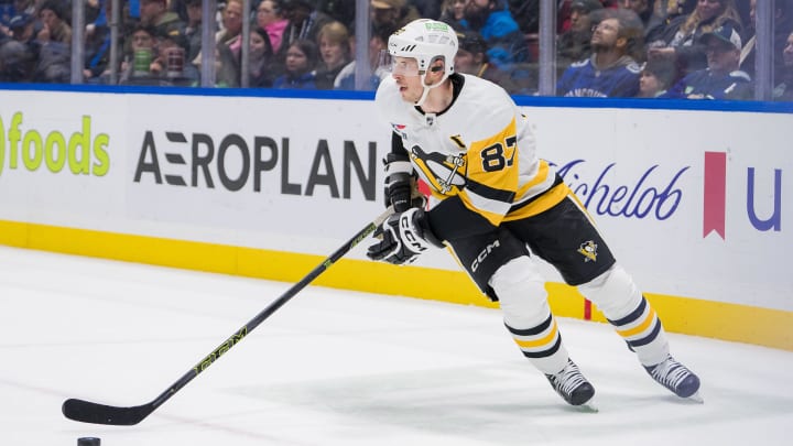 Feb 27, 2024; Vancouver, British Columbia, CAN; Pittsburgh Penguins forward Sidney Crosby (87) handles the puck against the Vancouver Canucks in the third period at Rogers Arena. Penguins won 4-3 in overtime. Mandatory Credit: Bob Frid-USA TODAY Sports