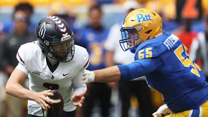Aug 30, 2025; Pittsburgh, Pennsylvania, USA; Pittsburgh Panthers defensive lineman Sean FitzSimmons (55) pressures Duquesne Dukes quarterback Tyler Riddell (2) during the first quarter at Acrisure Stadium. Mandatory Credit: Charles LeClaire-Imagn Images