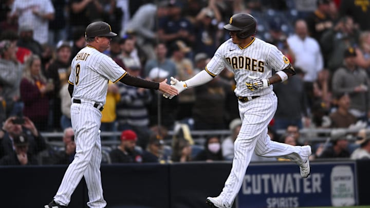 Apr 19, 2022; San Diego, California, USA; San Diego Padres third baseman Manny Machado (right) is congratulated by third base coach Mike Shildt (8) after hitting a two-run home run against the Cincinnati Reds during the first inning at Petco Park. Mandatory Credit: Orlando Ramirez-Imagn Images
