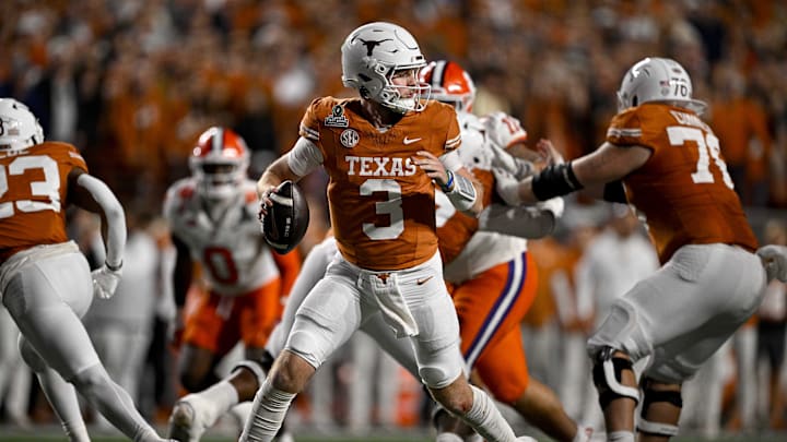 Texas Longhorns quarterback Quinn Ewers (3) rolls out to pass against the Clemson Tigers during the second half of the CFP National Playoff first-round game at Darrell K Royal-Texas Memorial Stadium.