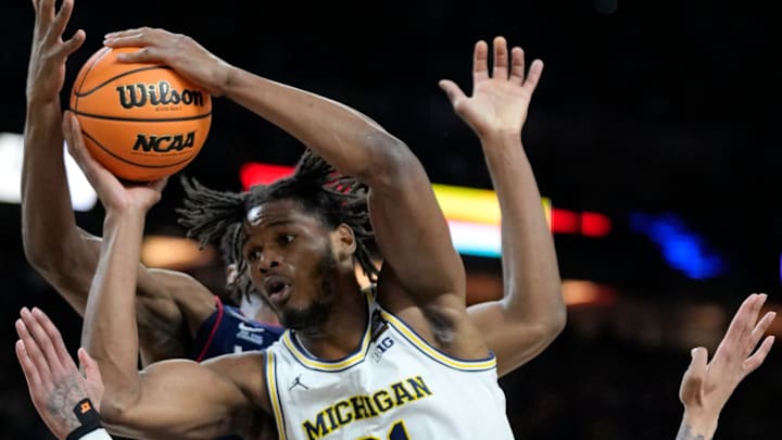 Michigan Wolverines forward Morez Johnson Jr. (21) drives past UConn Huskies guard Solo Ball (1) for the score Monday, April 6, 2026, during the NCAA men’s basketball national championship game at Lucas Oil Stadium in Indianapolis.
