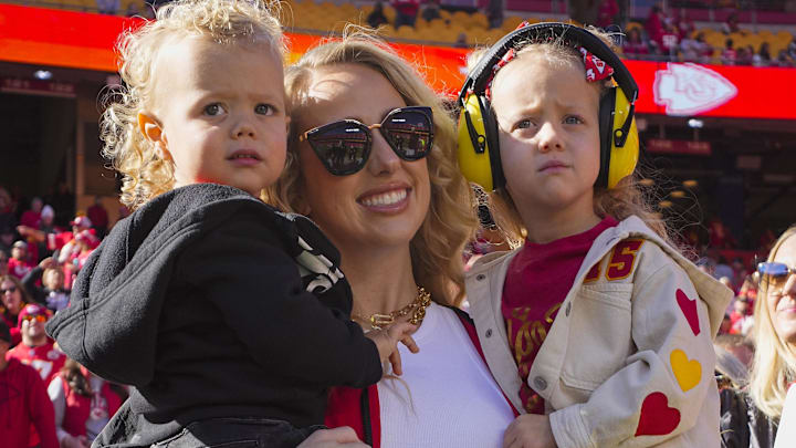 Brittany Mahomes and children watch warmups prior to game between the Kansas City Chiefs and the Denver Broncos at GEHA Field at Arrowhead Stadium.
