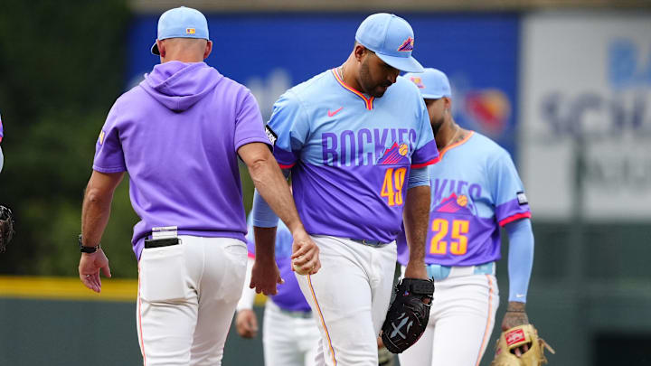 Aug 1, 2025; Denver, Colorado, USA; Colorado Rockies interim manager Warren Schaeffer (34) pulls starting pitcher Antonio Senzatela (49) in the first inning against the Pittsburgh Pirates at Coors Field. 