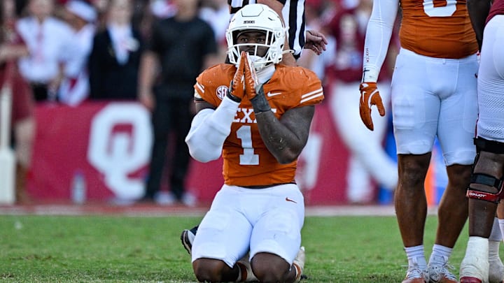 Texas Longhorns defensive end Colin Simmons (1) kneels on the field after the Longhorns stop the Oklahoma Sooners