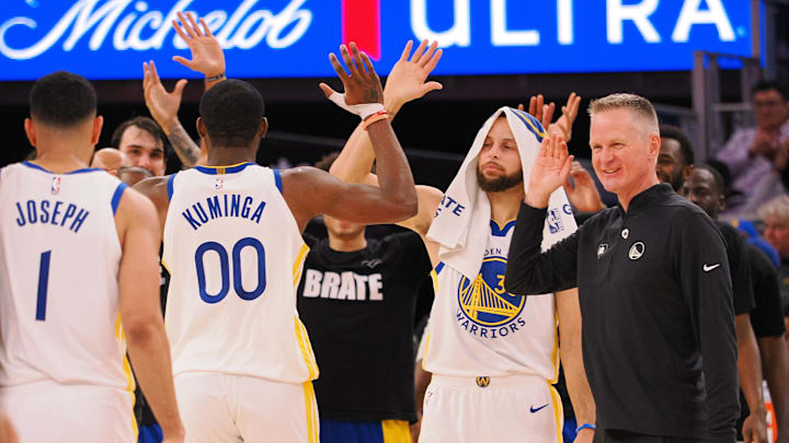 Jan 24, 2024; San Francisco, California, USA; Golden State Warriors forward Jonathan Kuminga (00) high fives guard Stephen Curry (30) and head coach Steve Kerr as a time out is called against the Atlanta Hawks during the fourth quarter at Chase Center. Mandatory Credit: Kelley L Cox-Imagn Images