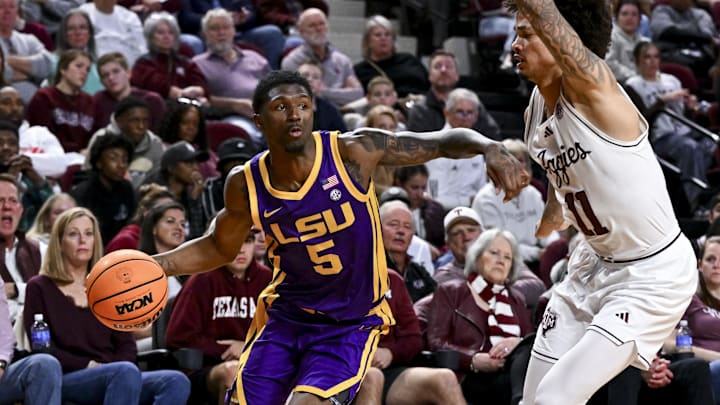 Jan 18, 2025; College Station, Texas, USA; LSU Tigers guard Cam Carter (5) drives to the basket during the second half as Texas A&M Aggies forward Andersson Garcia (11) defends at Reed Arena. The Aggies defeated the Tigers 68-57. Mandatory Credit: Maria Lysaker-Imagn Images Jan 18, 2025; College Station, Texas, USA; LSU Tigers guard Cam Carter (5) drives to the basket during the second half as Texas A&M Aggies forward Andersson Garcia (11) defends at Reed Arena. The Aggies defeated the Tigers 68-57. Mandatory Credit: Maria Lysaker-Imagn Images
