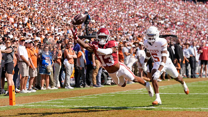 Oklahoma Sooners wide receiver J.J. Hester (13) can not make a catch as Texas Longhorns defensive back Malik Muhammad (5) defends in the first half of the Red River Rivalry college football game between the University of Oklahoma Sooners and the Texas Longhorn at the Cotton Bowl Stadium in Dallas, Texas, Saturday, Oct., 12, 2024.