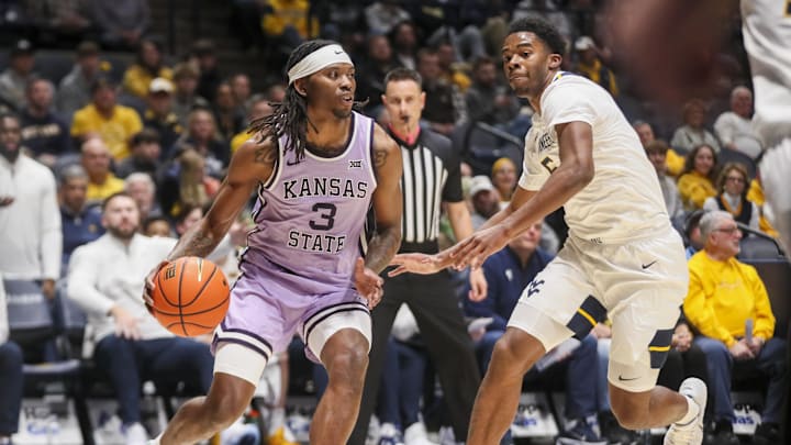 Jan 27, 2026; Morgantown, West Virginia, USA; Kansas State Wildcats guard CJ Jones (3) drives baseline against West Virginia Mountaineers forward DJ Thomas (5) during the first half at Hope Coliseum. Mandatory Credit: Ben Queen-Imagn Images