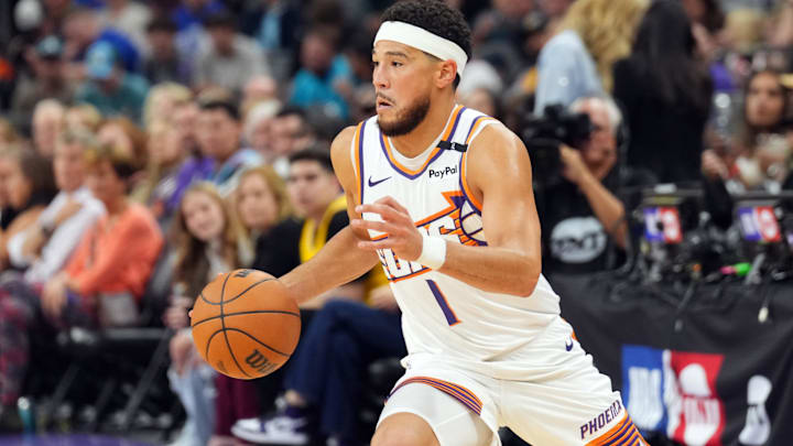 Oct 17, 2024; Phoenix, Arizona, USA; Phoenix Suns guard Devin Booker (1) dribbles against the Los Angeles Lakers during the first half at Footprint Center. Mandatory Credit: Joe Camporeale-Imagn Images