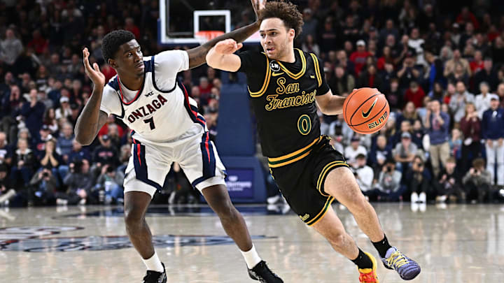 San Francisco guard Ryan Beasley (0) drives past Gonzaga  guard Tyon Grant-Foster (7) in Spokane. 