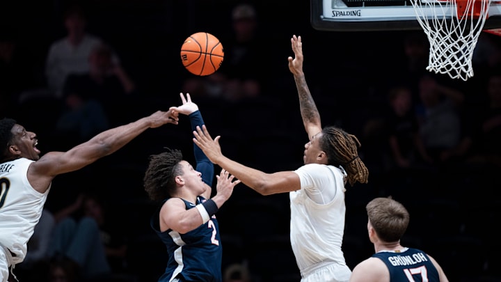 Virginia guard Chance Mallory (2) between Vanderbilt forward Tyler Harris (8) and forward AK Okereke (10) during the second half of their exhibition game at Memorial Gym in Nashville, Tenn., Thursday, Oct. 16, 2025.