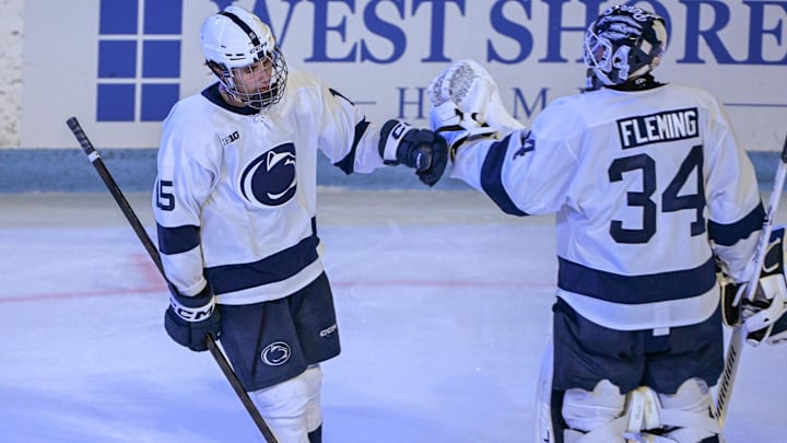 Penn State Nittany Lions forward Charlie Cerrato (15) celebrates a goal with goaltender Joshua Fleming (34) Penn State Nittany Lions forward Charlie Cerrato (15) celebrates a goal with goaltender Joshua Fleming (34)