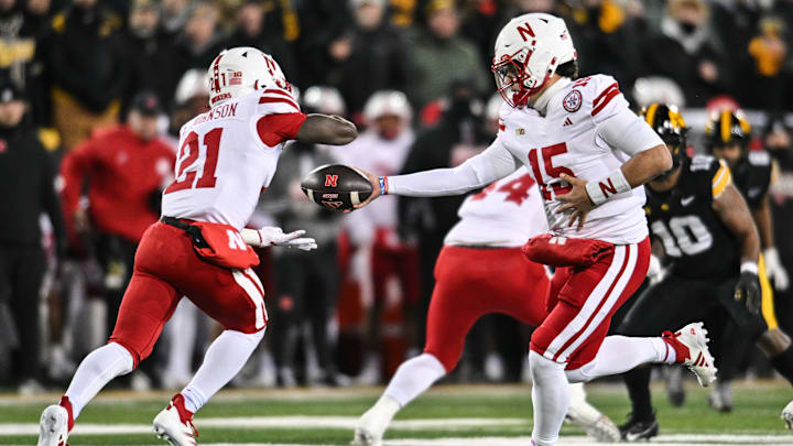 Nov 29, 2024; Iowa City, Iowa, USA; Nebraska Cornhuskers quarterback Dylan Raiola (15) hands the ball off to running back Emmett Johnson (21) against the Iowa Hawkeyes during the first quarter at Kinnick Stadium. Nov 29, 2024; Iowa City, Iowa, USA; Nebraska Cornhuskers quarterback Dylan Raiola (15) hands the ball off to running back Emmett Johnson (21) against the Iowa Hawkeyes during the first quarter at Kinnick Stadium.