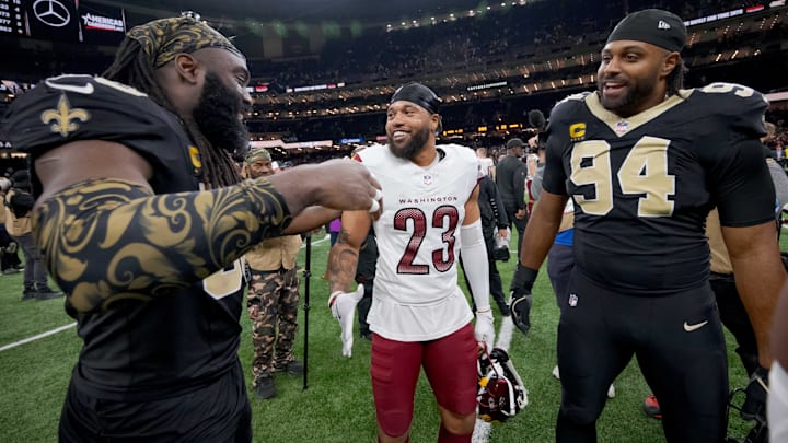 New Orleans Saints linebacker Demario Davis (56) and defensive end Cameron Jordan (94)greets former teammate Marshon Lattimore (23) of Washington 