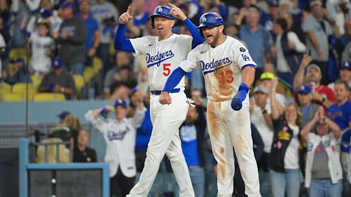 Sep 30, 2025; Los Angeles, California, USA; Los Angeles Dodgers first baseman Freddie Freeman (5) and Los Angeles Dodgers third baseman Max Muncy (13) celebrate after scoring on a three run home run from Los Angeles Dodgers right fielder Teoscar Hernandez (37) (not pictured) during the third inning against the Cincinnati Reds during game one of the Wildcard round for the 2025 MLB playoffs at Dodger Stadium. Mandatory Credit: Jayne Kamin-Oncea-Imagn Images Sep 30, 2025; Los Angeles, California, USA; Los Angeles Dodgers first baseman Freddie Freeman (5) and Los Angeles Dodgers third baseman Max Muncy (13) celebrate after scoring on a three run home run from Los Angeles Dodgers right fielder Teoscar Hernandez (37) (not pictured) during the third inning against the Cincinnati Reds during game one of the Wildcard round for the 2025 MLB playoffs at Dodger Stadium. Mandatory Credit: Jayne Kamin-Oncea-Imagn Images