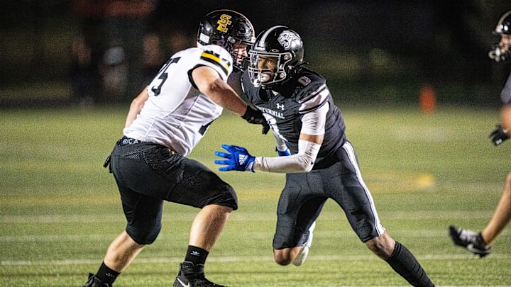 Ankeny Centennial's Malachi Curvey (0) sheds his blocker as he looks to get to the Southeast Polk quarterback on Friday, Sept. 20, 2024, at Ankeny Stadium.
