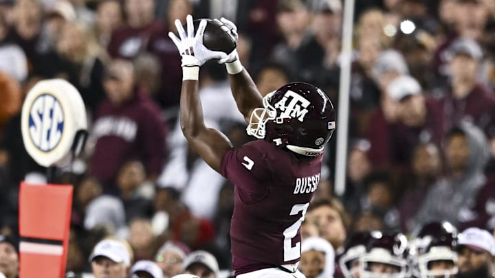 Texas A&M Aggies wide receiver Terry Bussey (2) leaps to catch a pass over Texas Longhorns defensive back Jahdae Barron (7) during the first half. The Longhorns defeated the Aggies 17-7 at Kyle Field. Mandatory Credit: Maria Lysaker-Imagn Images  