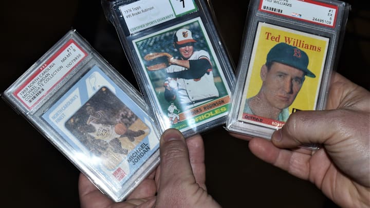 Vintage sports cards including a 1958 Ted Williams Tops card.