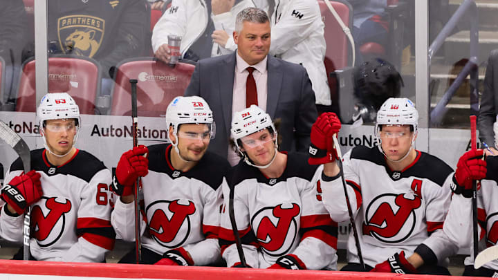 Nov 14, 2024; Sunrise, Florida, USA; New Jersey Devils head coach Sheldon Keefe watches from the bench against the Florida Panthers during the third period at Amerant Bank Arena. Mandatory Credit: Sam Navarro-Imagn Images