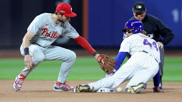 Oct 8, 2024; New York City, New York, USA; New York Mets outfielder Harrison Bader (44) steals second base against Philadelphia Phillies shortstop Trea Turner (7) in the seventh inning during game three of the NLDS for the 2024 MLB Playoffs at Citi Field.