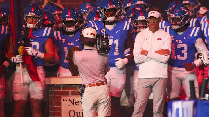 Nov 15, 2025; Oxford, Mississippi, USA; Mississippi Rebels head coach Lane Kiffin stands with his players before a game against the Florida Gators at Vaught-Hemingway Stadium. Mandatory Credit: Petre Thomas-Imagn Images