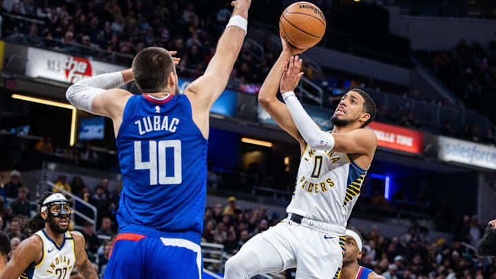 Dec 18, 2023; Indianapolis, Indiana, USA;  Indiana Pacers guard Tyrese Haliburton (0) shoots the ball while LA Clippers center Ivica Zubac (40) defends in the second half at Gainbridge Fieldhouse. Mandatory Credit: Trevor Ruszkowski-Imagn Images