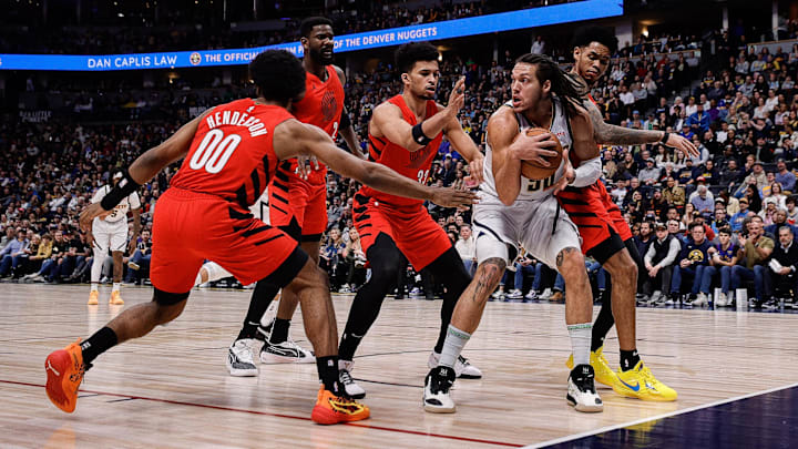 Feb 4, 2024; Denver, Colorado, USA; Denver Nuggets forward Aaron Gordon (50) controls the ball under pressure from Portland Trail Blazers guard Scoot Henderson (00) and center Deandre Ayton (2) and forward Toumani Camara (33) and guard Anfernee Simons (1) in the first quarter at Ball Arena. Mandatory Credit: Isaiah J. Downing-Imagn Images Feb 4, 2024; Denver, Colorado, USA; Denver Nuggets forward Aaron Gordon (50) controls the ball under pressure from Portland Trail Blazers guard Scoot Henderson (00) and center Deandre Ayton (2) and forward Toumani Camara (33) and guard Anfernee Simons (1) in the first quarter at Ball Arena. Mandatory Credit: Isaiah J. Downing-Imagn Images