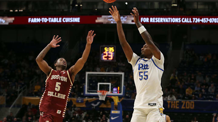 Mar 8, 2025; Pittsburgh, Pennsylvania, USA;  Pittsburgh Panthers forward Zack Austin (55) shoots a three point basket against Boston College Eagles guard Fred Payne (5) during the second half at the Petersen Events Center. Mandatory Credit: Charles LeClaire-Imagn Images