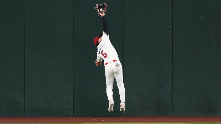 Mar 28, 2024; Phoenix, Arizona, USA; Arizona Diamondbacks center fielder Alek Thomas (5) makes a leaping catch against the Colorado Rockies during the fourth inning at Chase Field. Mandatory Credit: Joe Camporeale-USA TODAY Sports Mar 28, 2024; Phoenix, Arizona, USA; Arizona Diamondbacks center fielder Alek Thomas (5) makes a leaping catch against the Colorado Rockies during the fourth inning at Chase Field. Mandatory Credit: Joe Camporeale-USA TODAY Sports