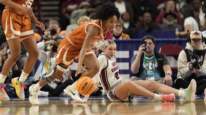March 9, 2025; Greenville, SC, USA; Texas Longhorns guard Rori Harmon (3) grabs a loose ball as South Carolina Gamecocks forward Chloe Kitts (21) watches during the first half at Bon Secours Wellness Arena. Mandatory Credit: Jim Dedmon-Imagn Images