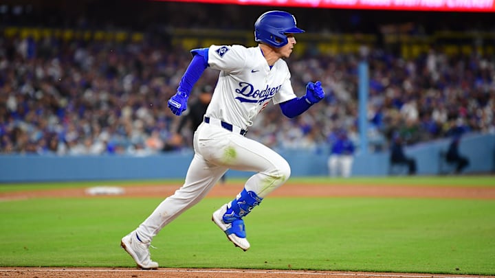 Apr 2, 2025; Los Angeles, California, USA; Los Angeles Dodgers second baseman Tommy Edman (25) runs after hitting a single against the Atlanta Braves during the sixth inning at Dodger Stadium. Mandatory Credit: Gary A. Vasquez-Imagn Images