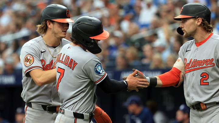 Aug 16, 2026; St. Petersburg, Florida, USA;  Baltimore Orioles second baseman Jackson Holliday (7) and first baseman Coby Mayo (16) are congratulated by shortstop Gunnar Henderson (2) after they scored during the fifth inning against the Tampa Bay Rays at Tropicana Field. Mandatory Credit: Kim Klement Neitzel-Imagn Images