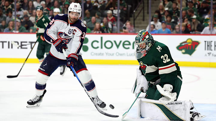 Blue Jackets captain Boone Jenner tries to deflect a puck past Wild goaltender Filip Gustavsson.